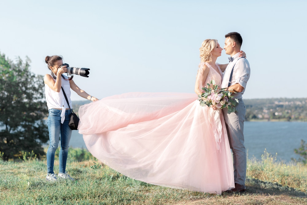 Wedding,Photographer,Takes,Pictures,Of,Bride,And,Groom,In,Nature.